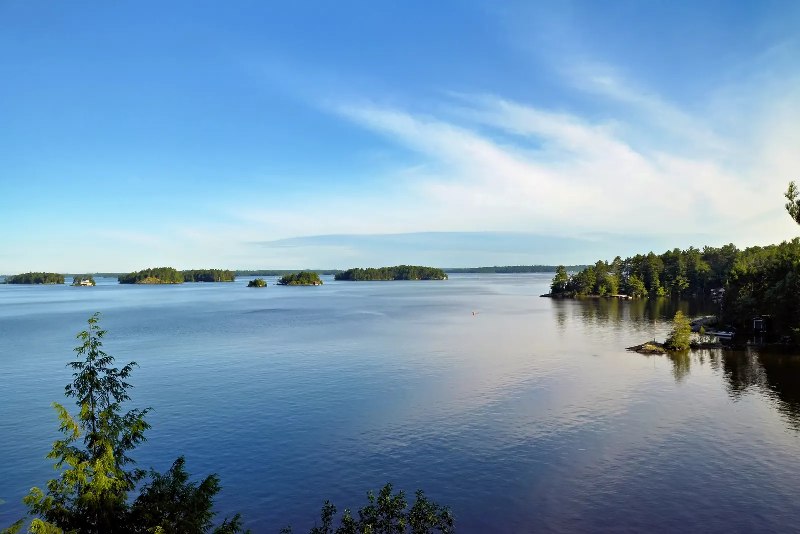 Calm blue lake framed by pine forest in Ontario’s Muskoka region