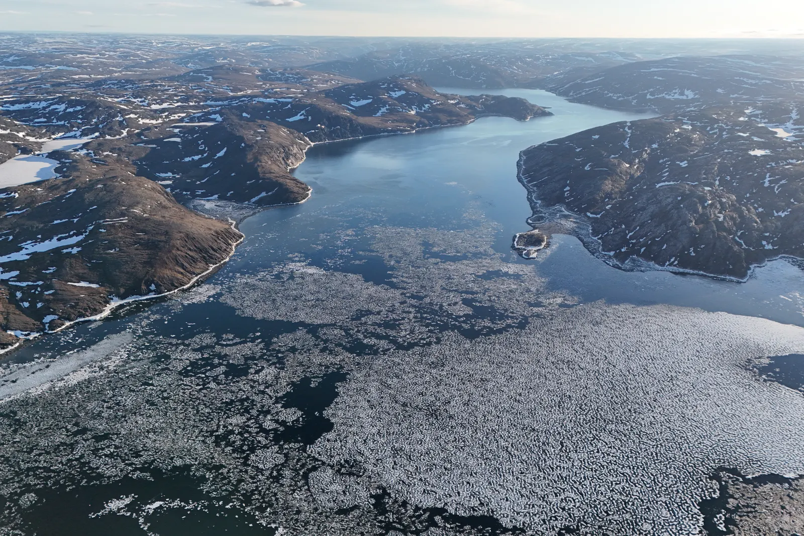 Aerial view of snow, ice and deep fjords in the Arctic landscape of Nunavut