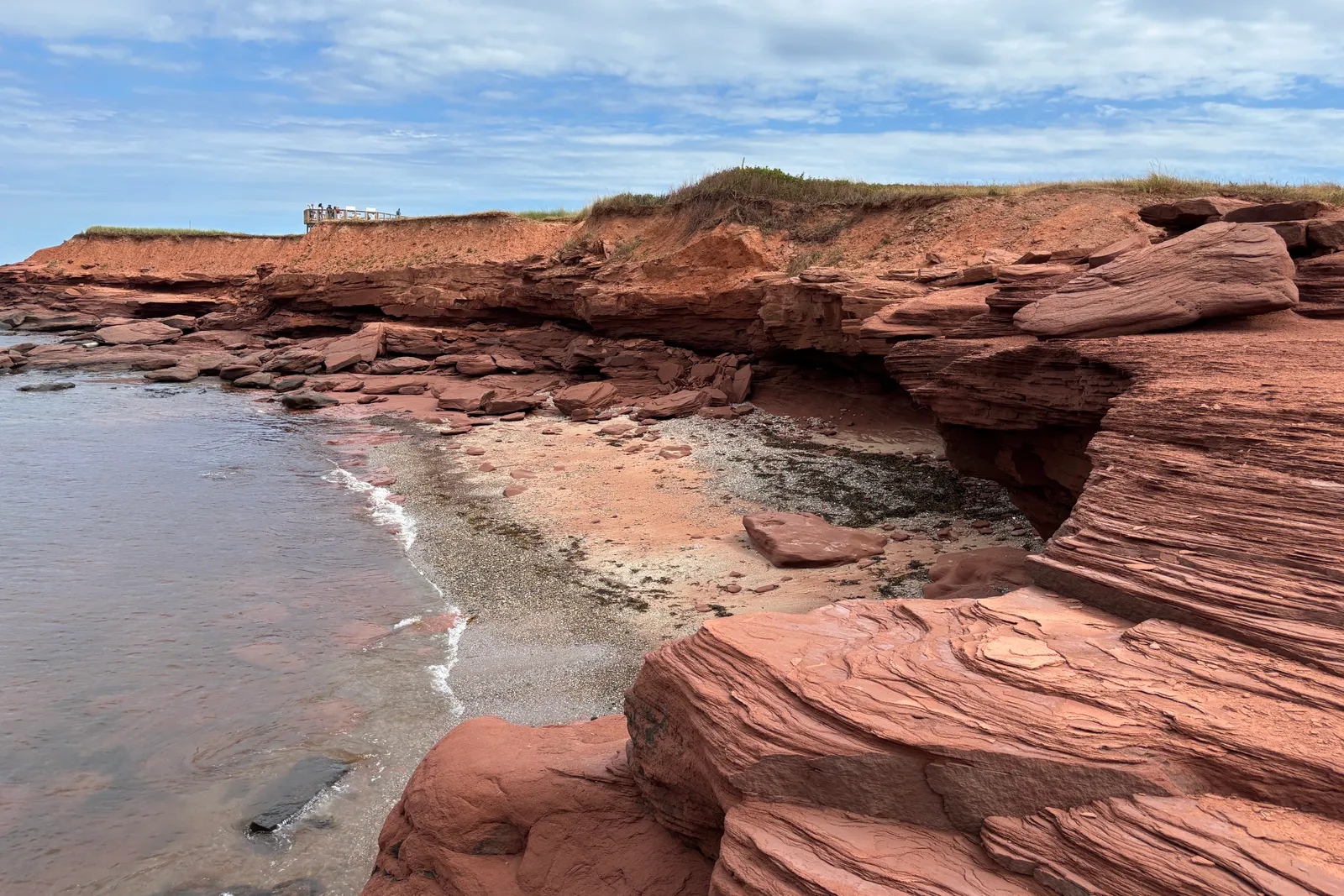 Red sandstone cliffs and blue water along the coast at Cavendish, Prince Edward Island